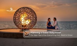 Pregnant couple enjoying a romantic Dubai babymoon with city views and New Year celebrations