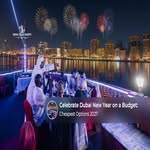 Crowds enjoying Dubai's New Year's Eve celebrations with the city skyline illuminated at night.